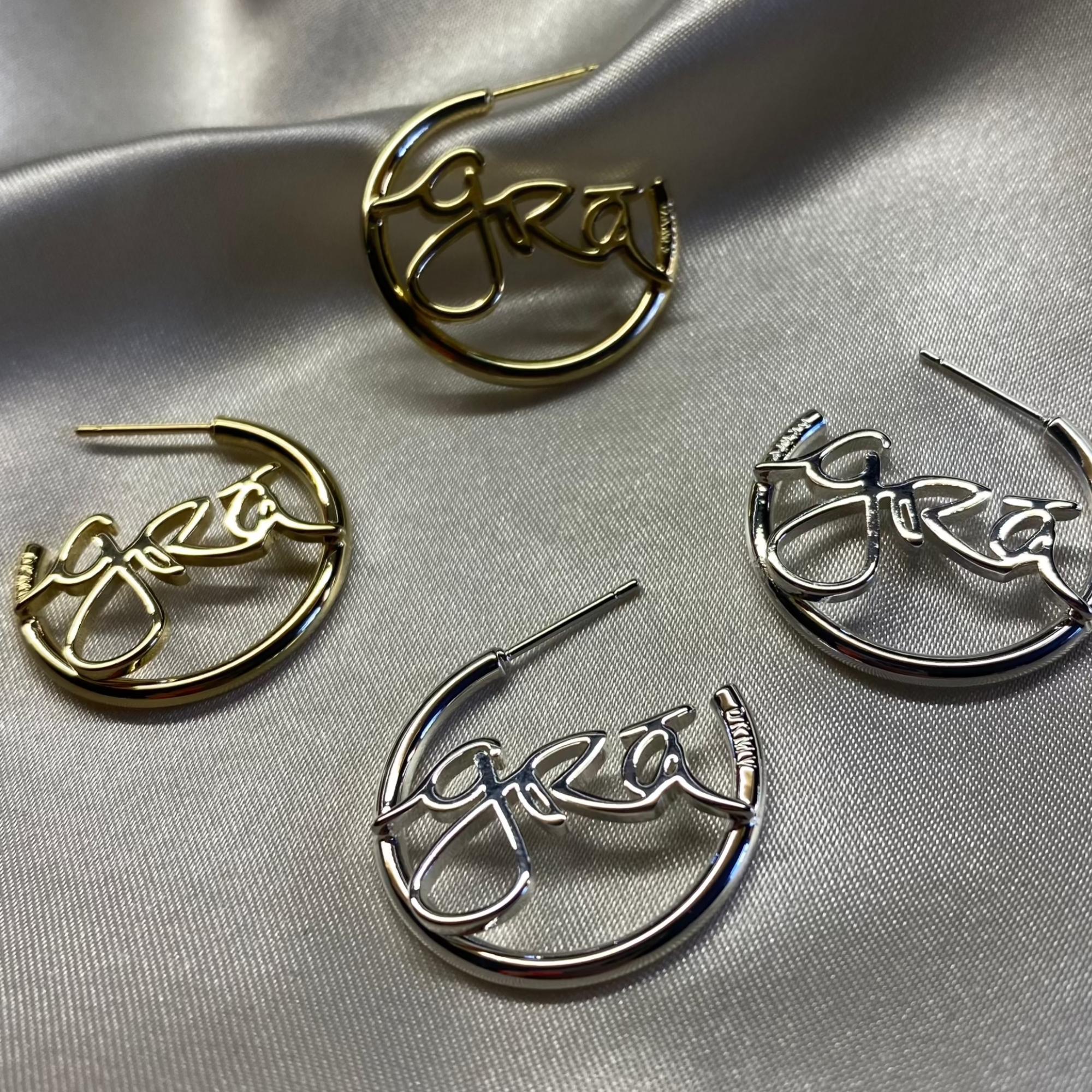 Gold and Silver Grá Beag Hoop Earrings on grey silk