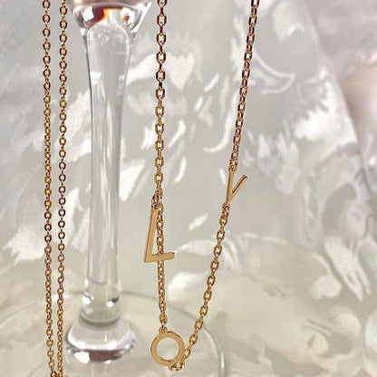 Close-up of Gold L.O.V.E double necklace 